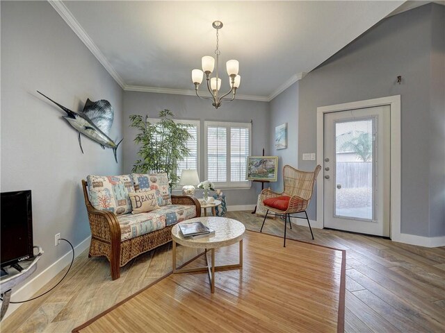 living room with hardwood / wood-style flooring, plenty of natural light, and ornamental molding