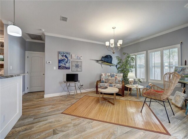 sitting room featuring wood-type flooring, ornamental molding, and an inviting chandelier