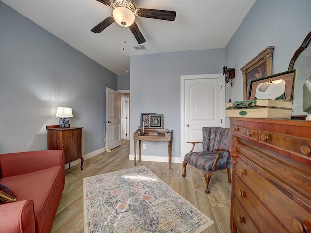 living area featuring light hardwood / wood-style floors and ceiling fan