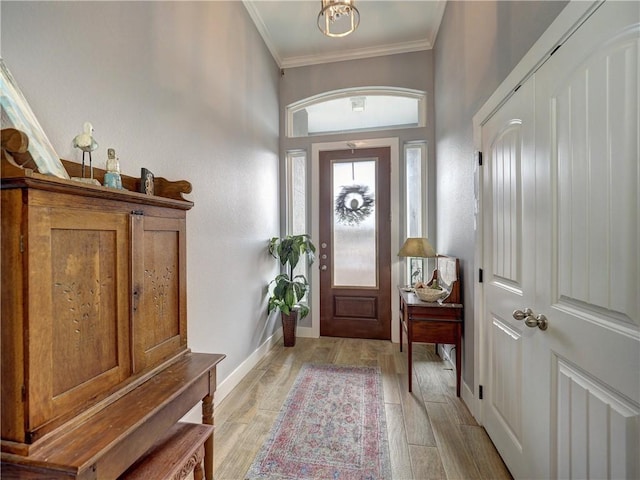 entryway featuring crown molding and light wood-type flooring