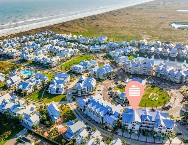 bird's eye view with a water view, a residential view, and a view of the beach