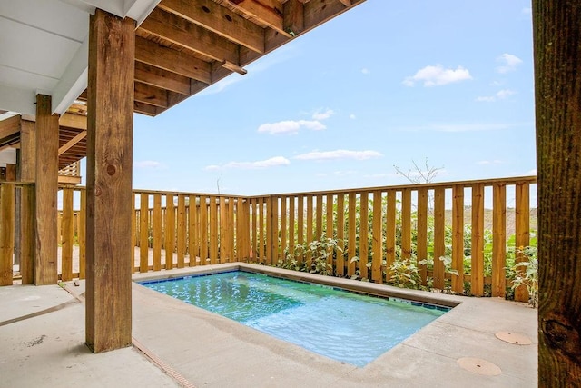 view of swimming pool with a jacuzzi