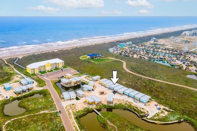 birds eye view of property with a water view and a view of the beach