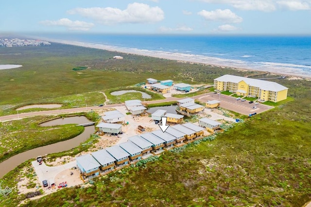 drone / aerial view with a water view and a view of the beach