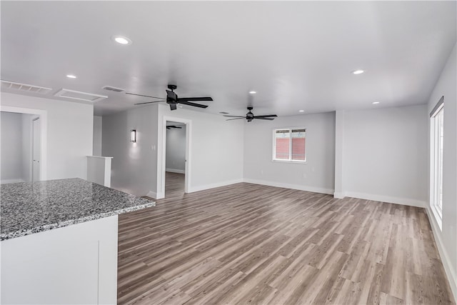 unfurnished living room with light hardwood / wood-style flooring and ceiling fan