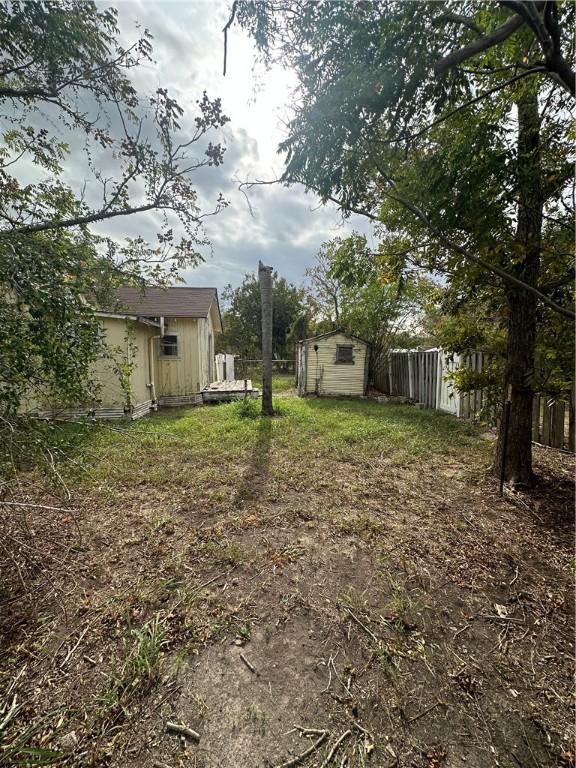308 Mcguill St, Refugio, TX 78377 - fenced backyard featuring a storage unit