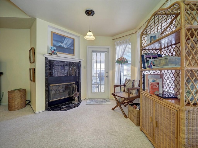 living area with carpet flooring and a tiled fireplace