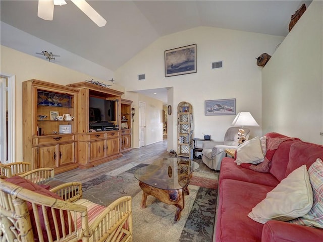 living room featuring hardwood / wood-style flooring, ceiling fan, and high vaulted ceiling