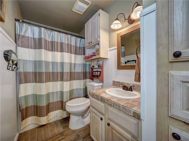 bathroom with hardwood / wood-style floors, vanity, and toilet