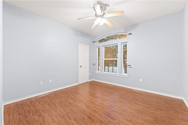 empty room with hardwood / wood-style floors and ceiling fan