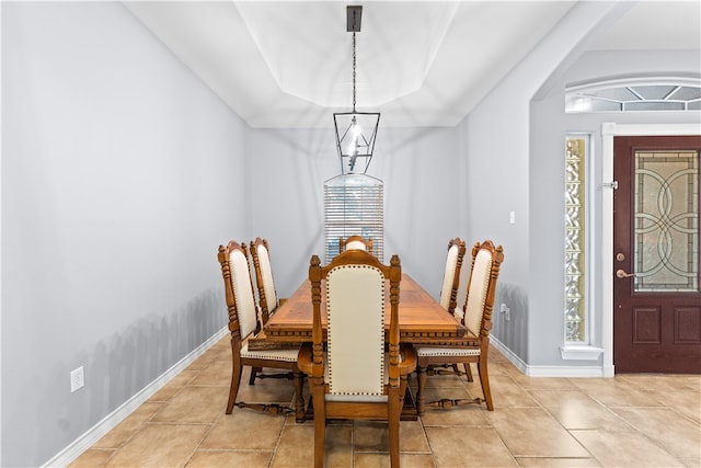 dining room with a chandelier and light tile patterned floors