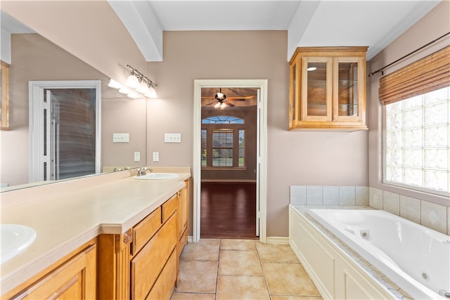 bathroom featuring vanity, a tub to relax in, tile patterned flooring, and ceiling fan