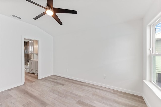 empty room featuring ceiling fan, lofted ceiling, and light hardwood / wood-style flooring