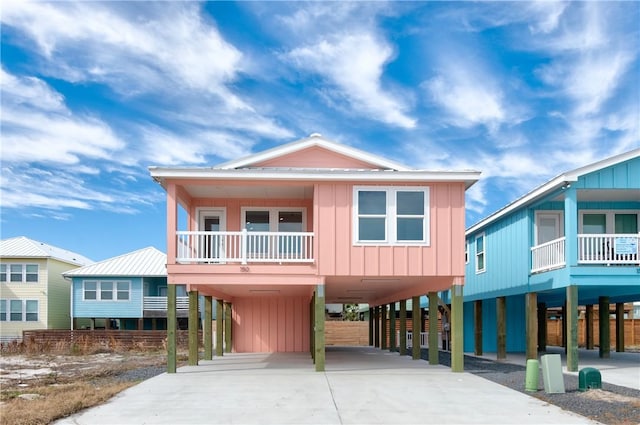 view of front of home featuring a carport and a balcony