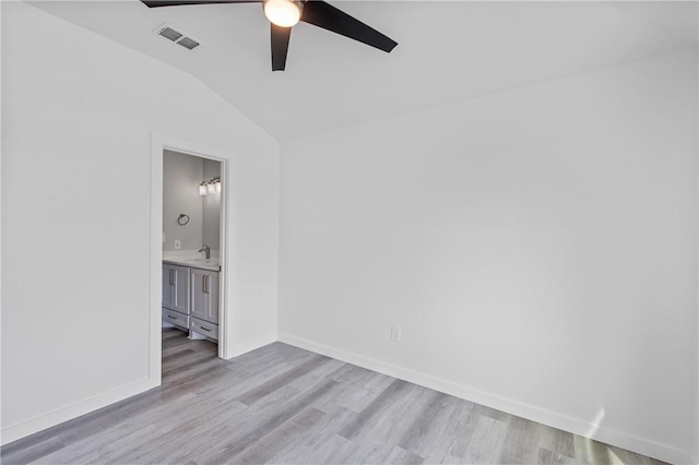 spare room with sink, vaulted ceiling, light hardwood / wood-style floors, and ceiling fan