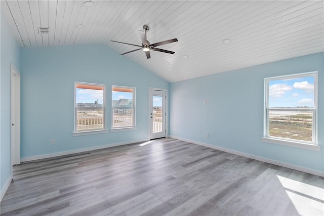 unfurnished room featuring hardwood / wood-style flooring, ceiling fan, plenty of natural light, and vaulted ceiling