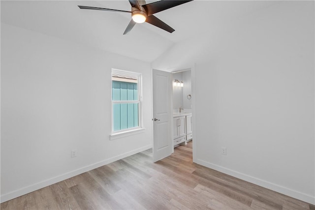 unfurnished room featuring light hardwood / wood-style flooring, ceiling fan, and vaulted ceiling