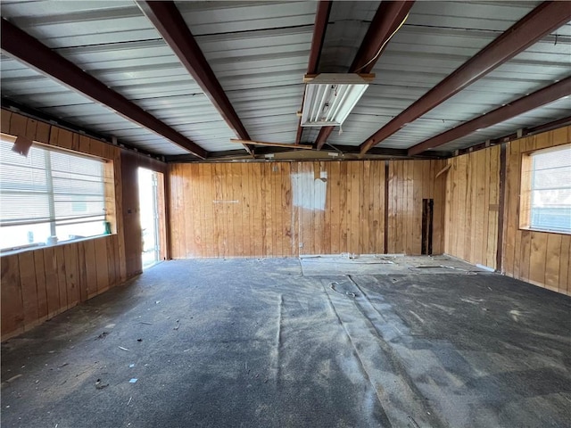 spare room featuring wooden walls