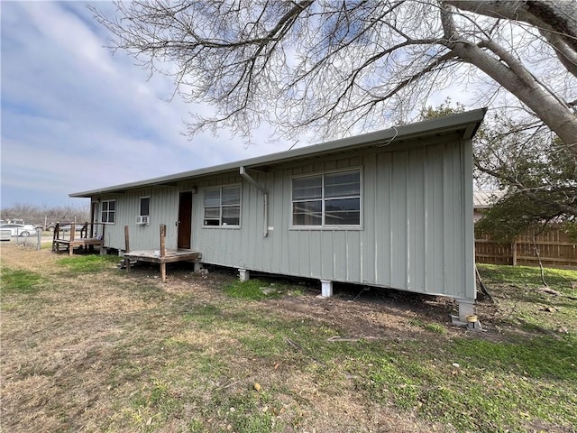 rear view of property featuring a yard