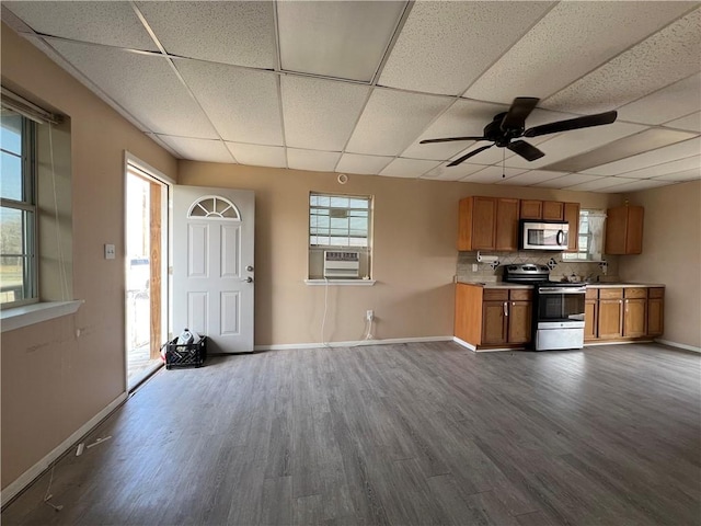 kitchen featuring cooling unit, stainless steel appliances, a paneled ceiling, and dark wood-type flooring