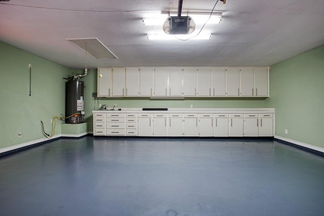 garage with baseboards, gas water heater, and a garage door opener