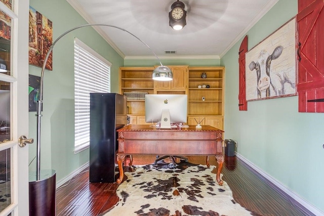 office area featuring arched walkways, crown molding, a ceiling fan, wood finished floors, and baseboards