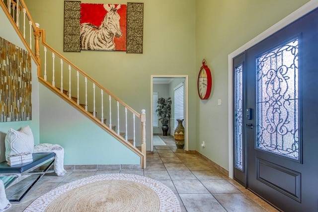 entrance foyer featuring tile patterned flooring and plenty of natural light