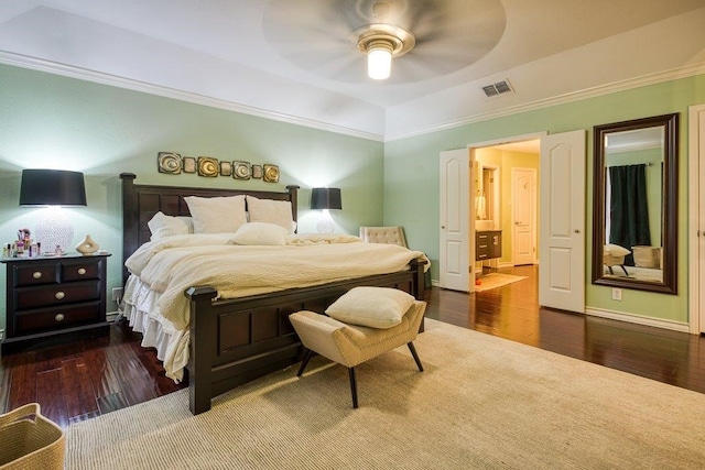 bedroom featuring visible vents, wood finished floors, and ornamental molding