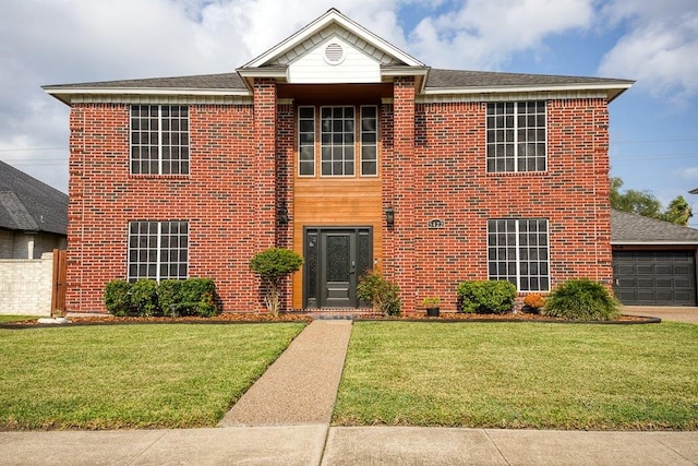 view of front facade featuring a garage, a front lawn, and brick siding