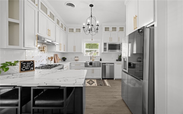 kitchen featuring light stone counters, stainless steel appliances, sink, white cabinets, and dark hardwood / wood-style floors