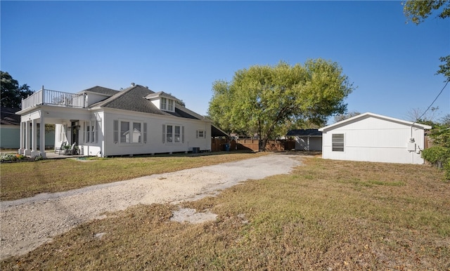 view of home's exterior featuring a yard, a balcony, and a porch