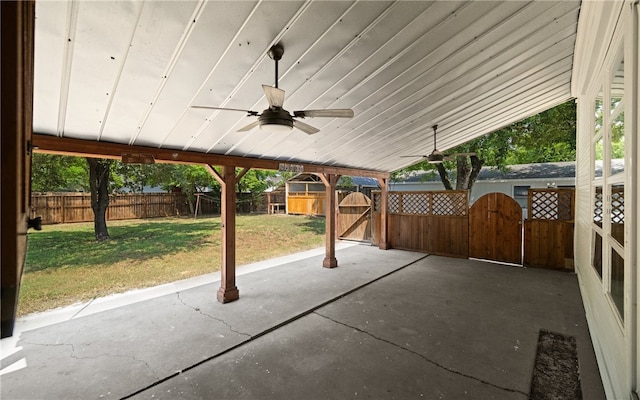 view of patio with ceiling fan and an outdoor structure