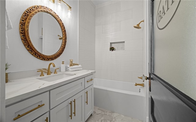 bathroom featuring tiled shower / bath combo and vanity