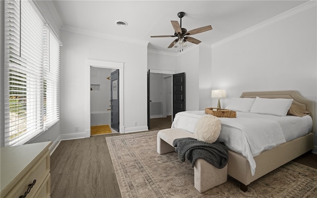 bedroom with ceiling fan, ornamental molding, dark wood-type flooring, and ensuite bath