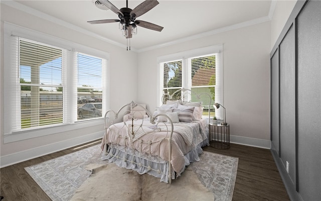 bedroom with ceiling fan, dark hardwood / wood-style flooring, and crown molding