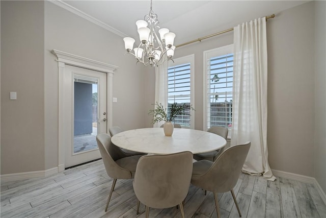 dining area featuring ornamental molding, baseboards, a notable chandelier, and light wood finished floors