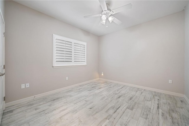 unfurnished room featuring a ceiling fan, light wood-type flooring, and baseboards