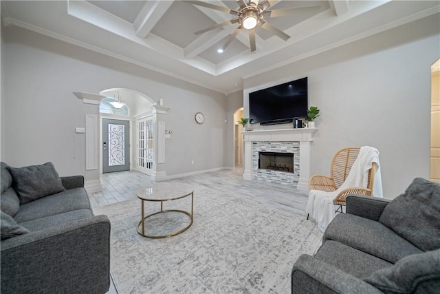 living room with a fireplace, coffered ceiling, crown molding, and beamed ceiling