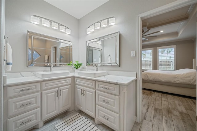 full bath with ceiling fan, ornamental molding, a sink, and wood finished floors