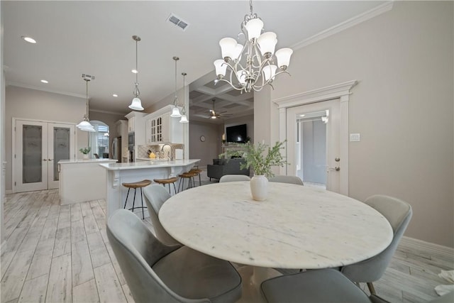 dining area featuring recessed lighting, visible vents, light wood-style floors, coffered ceiling, and ceiling fan with notable chandelier