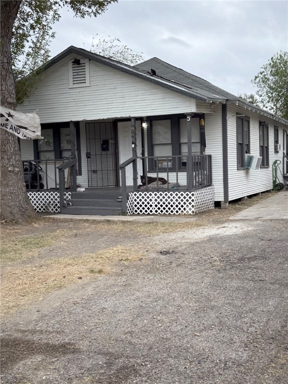 view of front of property featuring covered porch and cooling unit