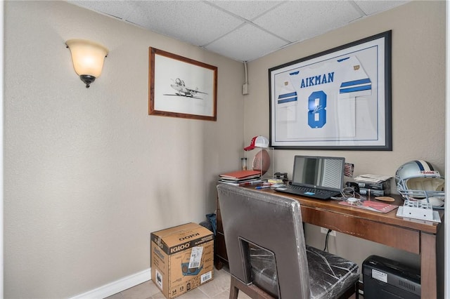 office featuring a drop ceiling and baseboards