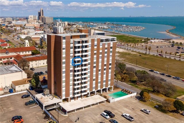 birds eye view of property featuring a view of city and a water view