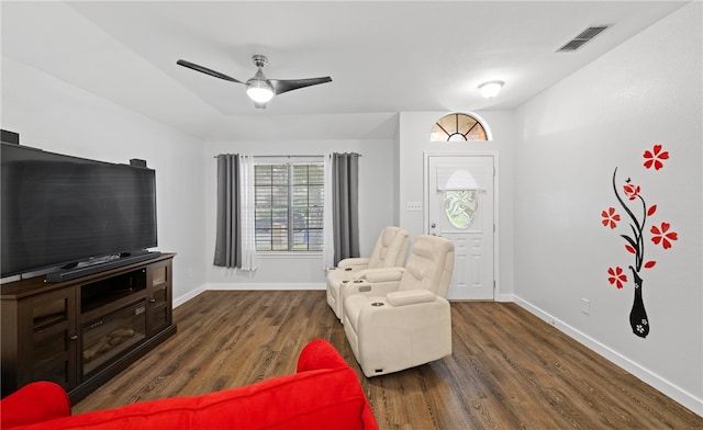 living area featuring ceiling fan and dark hardwood / wood-style flooring