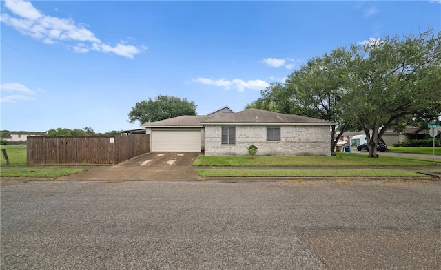 ranch-style home featuring a front yard and a garage