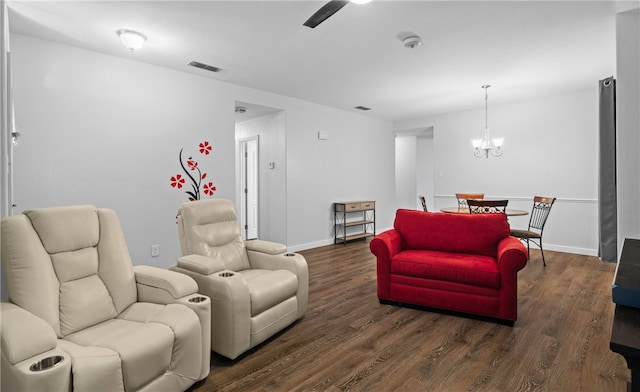 living room featuring a notable chandelier and dark hardwood / wood-style floors