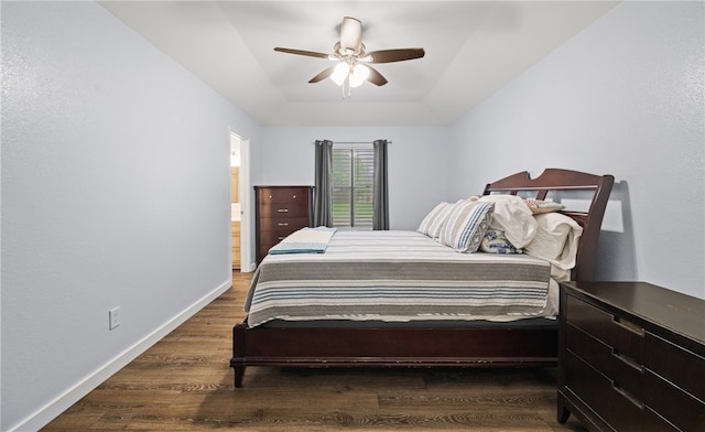 bedroom featuring dark wood-type flooring, ceiling fan, and ensuite bath