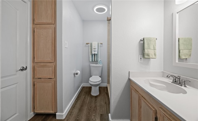 bathroom featuring hardwood / wood-style floors, vanity, and toilet