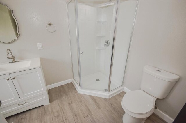 105 E Cornwall St, Rockport, TX 78382 - full bath featuring toilet, wood finished floors, vanity, a stall shower, and baseboards