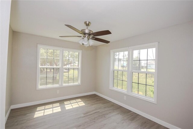 105 E Cornwall St, Rockport, TX 78382 - spare room with healthy amount of natural light, baseboards, and wood finished floors